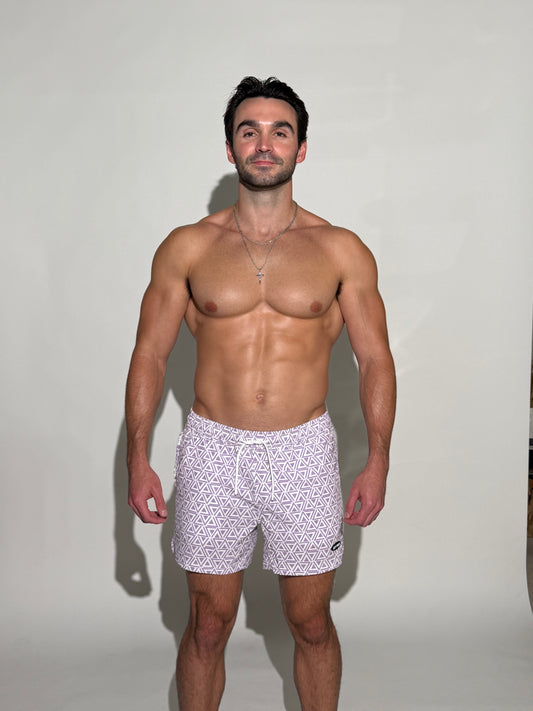 Model wearing the JETTIES Delta Purple, purple and white triangle mens bathing suit, geometric pattern