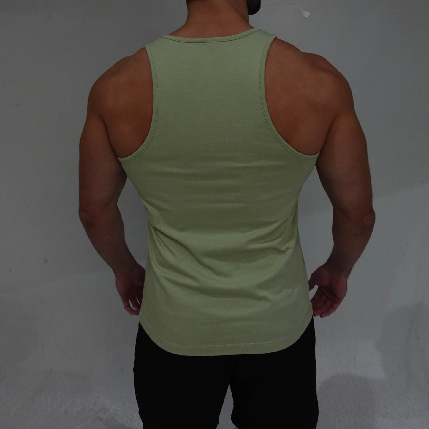 JETTIES Ascend Tank Top in matcha green, lightweight athletic tank with logo graphic, back view