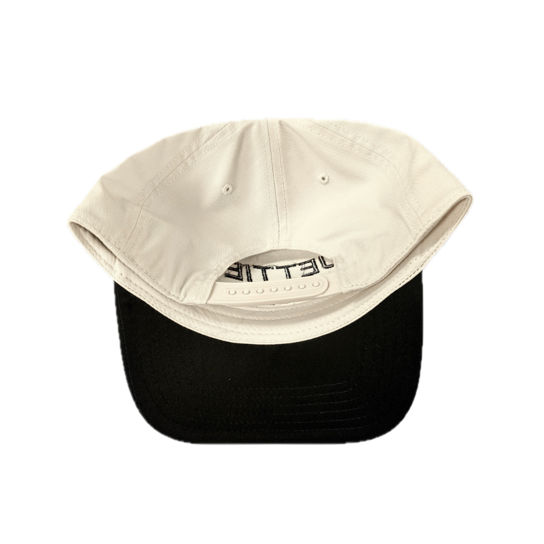JETTIES Relax & Recover snapback hat with black brim — structured beige crown and embroidered logo, bottom/under brim view.