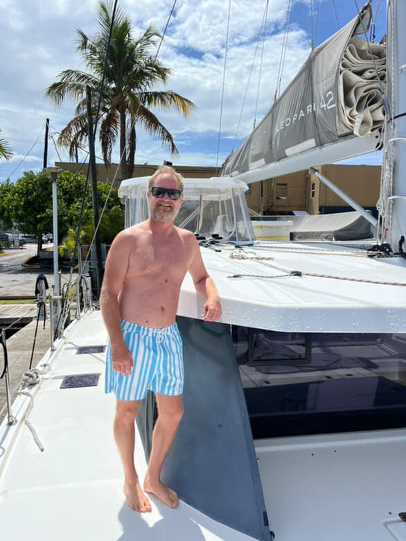 Captain of ship chilling on boat wearing JETTIES CODE BLUE PLUNGE SHORT bathing suit